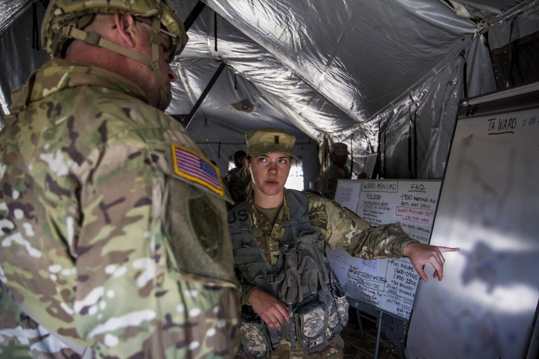 U.S. Army 1st Lt. Majken Geiman, 315th Engineer Battalion FSC, shows United States Army Reserve Command (USARC) Command Sgt. Maj. Ted Copeland a map of Tactical Assembly Area (TAA) Ward while it is being utilized during the Warrior Exercise (WAREX) on Fort Hunter Liggett, Calif. on June 12, 2017. Copeland takes a tour of TAA Ward to ensure that the 91st Training Division’s WAREX 91-17-03 is generating capable, lethal, combat ready forces. (U.S. Army photo by Spc. Sean McCallon, 91st Training Division public affairs/Released)