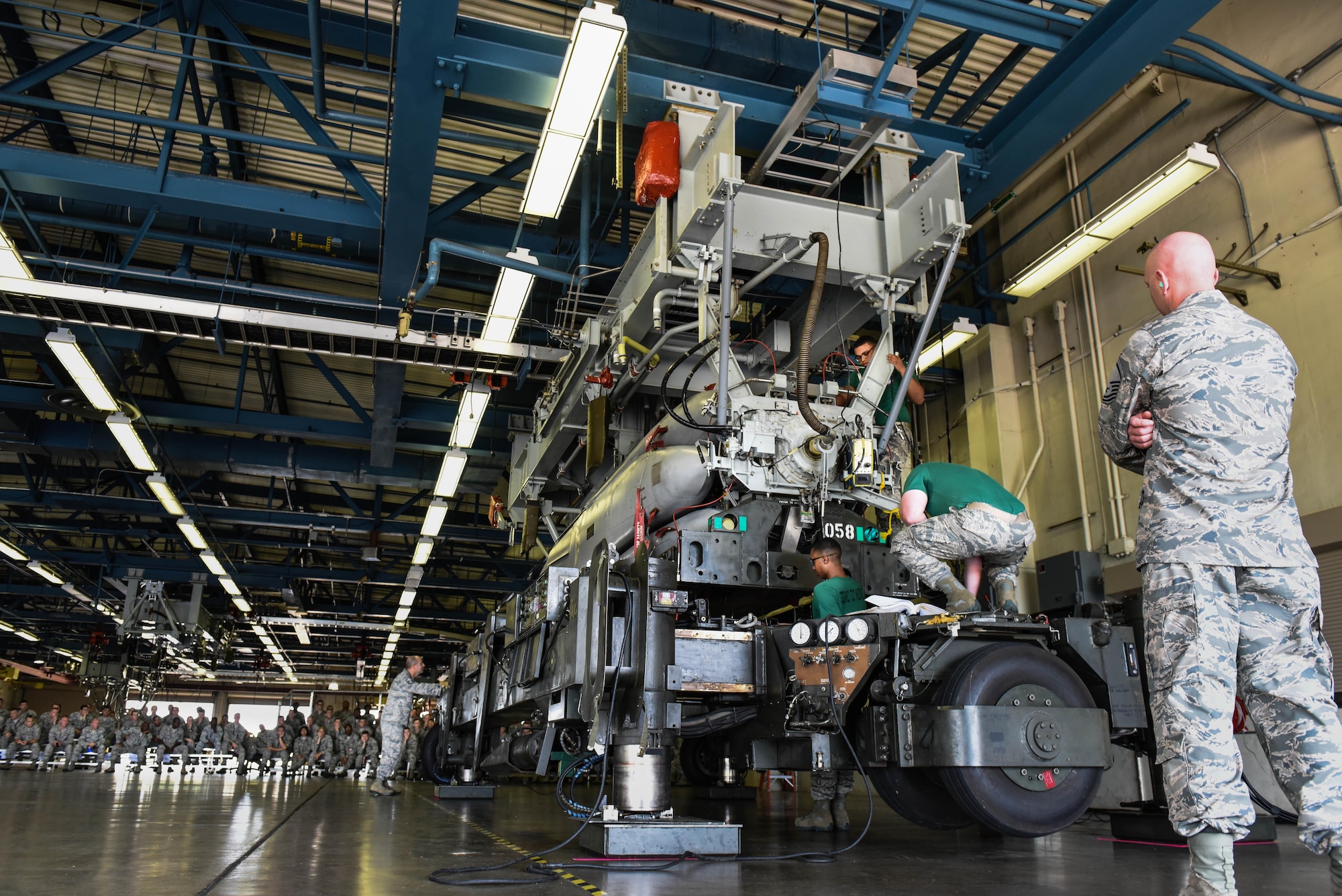 An inspector reviews Airmen from the 2nd Munitions Squadron as they upload missiles during the Air Force Global Strike Challenge on Barksdale Air Force Base, La., June 12, 2017. The team is inspected on their process of uploading missiles to ensure they are using all safety procedures as well testing how quickly they can assemble the missiles. (U.S. Air Force Photo/Airman 1st Class Sydney Bennett)