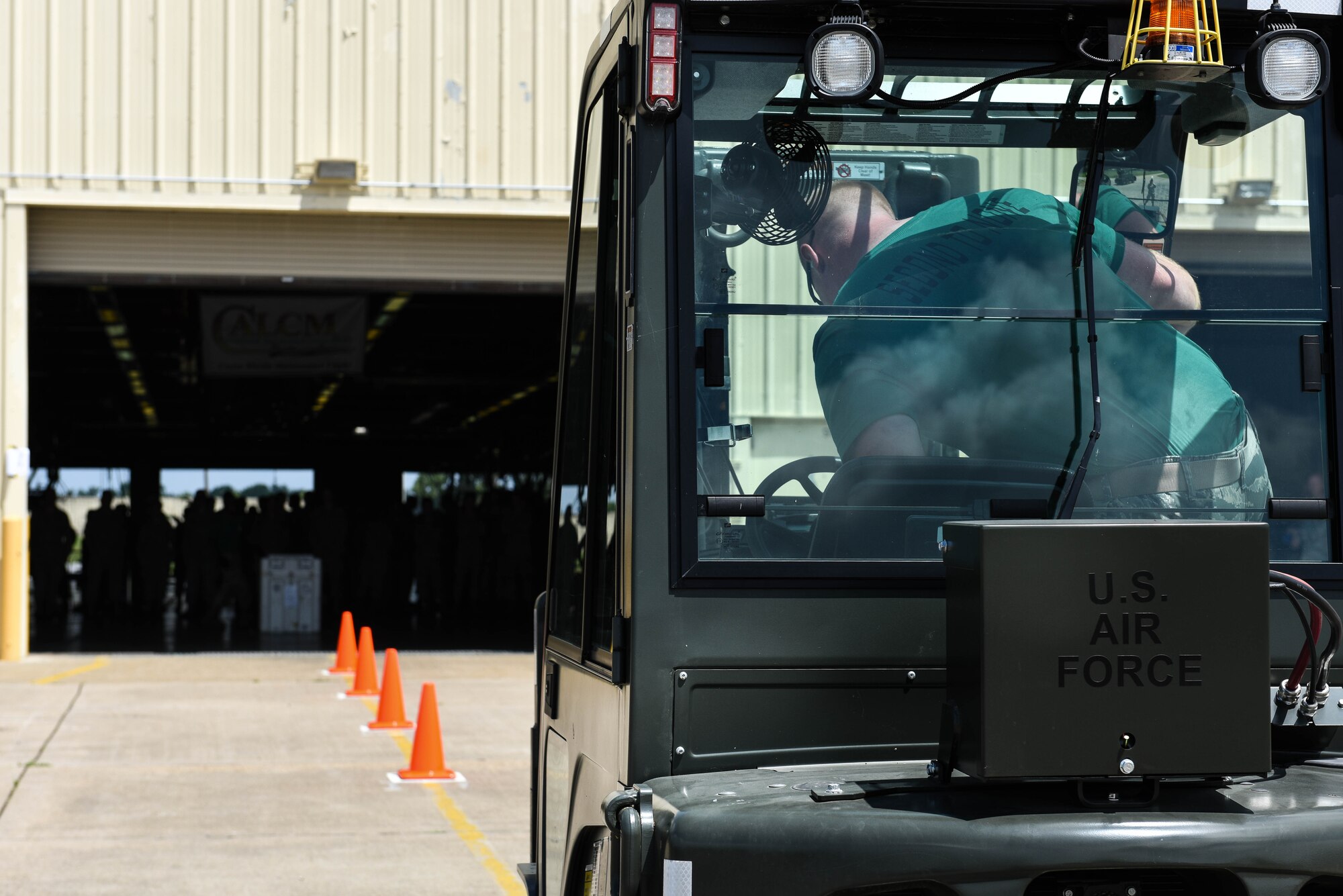 Staff Sgt. Joseph Travers, assigned to the 2nd Munitions, climbs into a forklift in preparation for one of four events in the Air Force Global Strike Challenge on Barksdale Air Force Base, La., June 12, 2017. Travers needed to drive between the cones, pick up a package and drive between the cones once more before dropping the package off at its final destination. (U.S. Air Force Photo/Airman 1st Class Sydney Bennett)