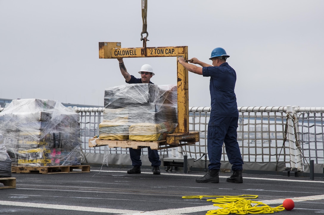 Crewmembers aboard the Coast Guard Cutter Waesche, homported in Alameda, California, offload approximately 18 tons of cocaine in San Diego on June 15, 2017. The drugs were seized in 18 separate interdictions from March to June 2017.
