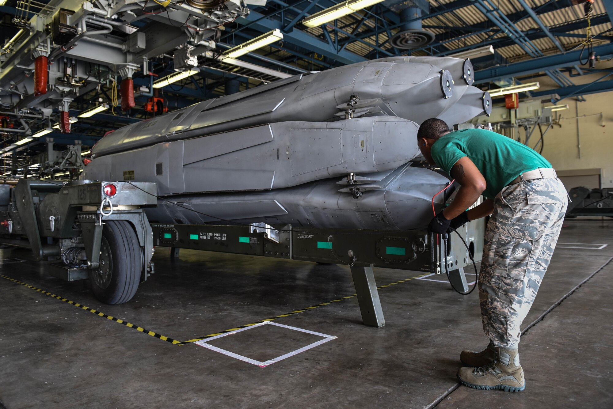 Senior Airman Terrance Jackson, assigned to the 2nd Munitions Squadron, guides a trailer around a missile rotator as part of a challenge in Air Force Global Strike Challenge on Barksdale Air Force Base, La., June 12, 2017. All four Airmen on the team were trained to do each of the tasks making the jobs interchangeable. (U.S. Air Force Photo/Airman 1st Class Sydney Bennett)