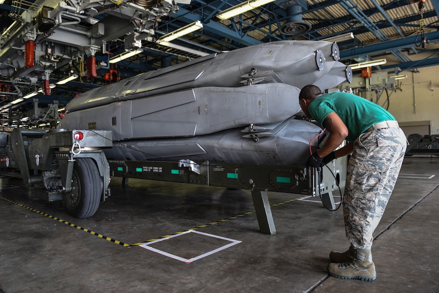 Senior Airman Terrance Jackson, assigned to the 2nd Munitions Squadron, guides a trailer around a missile rotator as part of a challenge in Air Force Global Strike Challenge on Barksdale Air Force Base, La., June 12, 2017. All four Airmen on the team were trained to do each of the tasks making the jobs interchangeable. (U.S. Air Force Photo/Airman 1st Class Sydney Bennett)