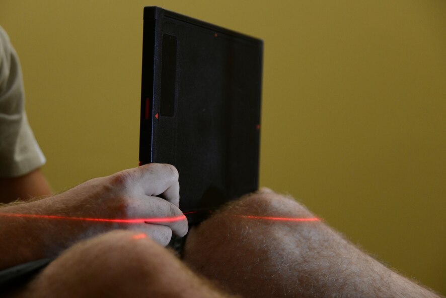 A patient holds an x-ray cassette behind his knee in a radiology room at Shaw Air Force Base, S.C., June 15, 2017. Placing a body part between the cassette and the x-ray machine allows the intended area to be isolated during the scan. (U.S. Air Force photo by Airman 1st Class Kathryn R.C. Reaves)