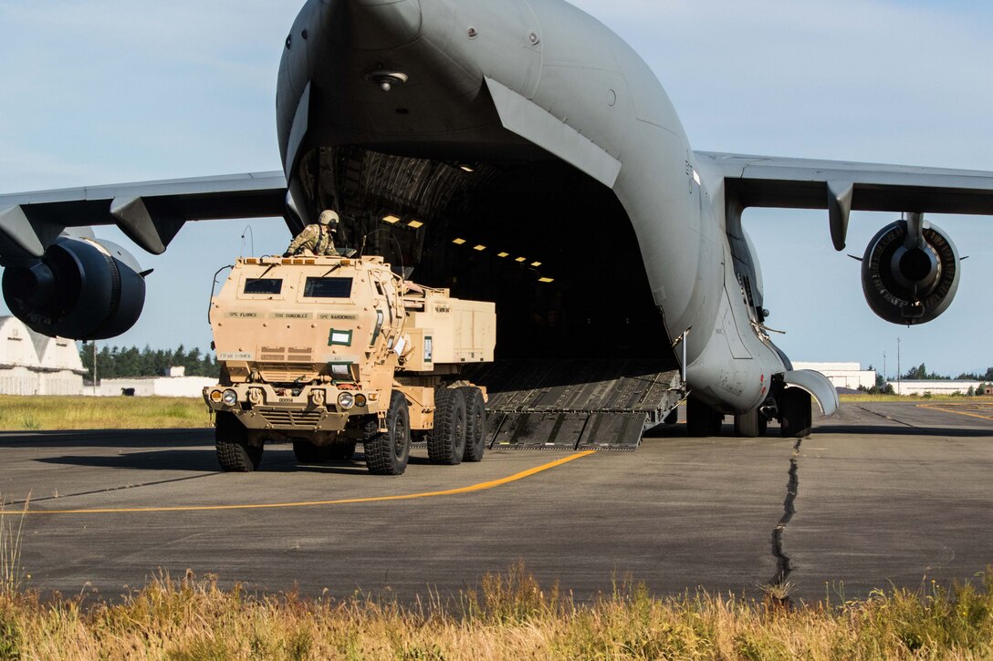 Staff Sgt. Rudy Gonzalez from A Battery, 1st Battalion, 94th Field Artillery Regiment, 17th Field Artillery Brigade of Rialto, Calif., helps guide his High Mobility Artillery Rocket System onto the C-17 Globemaster III in support of Operation Rainier War on Joint Base Lewis-McChord, Wash., June 7, 2017. 62nd Airlift Wing flew a HIMARS to Fort Hunter Liggett, Calif. to off load and fire a six round mission. (U.S. Army Photo by Sgt. Jacob Kohrs)