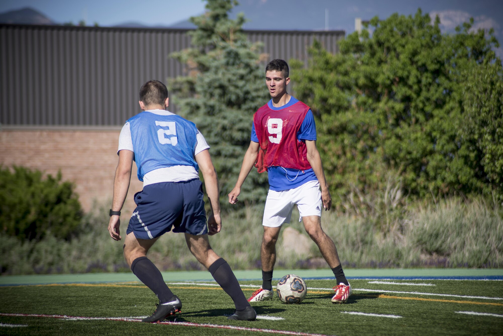 PETERSON AIR FORCE BASE, Colo. - Team Pete Airmen match up during a soccer game for Sports and Field Day, June 15, 2017, at Peterson Air Force Base, Colo. During the annual Sports and Field Day, Team Pete units compete for points based off the number of participants, volunteers and wins in the various sports and games held. (U.S. Air Force photo by Senior Airman Dennis Hoffman)