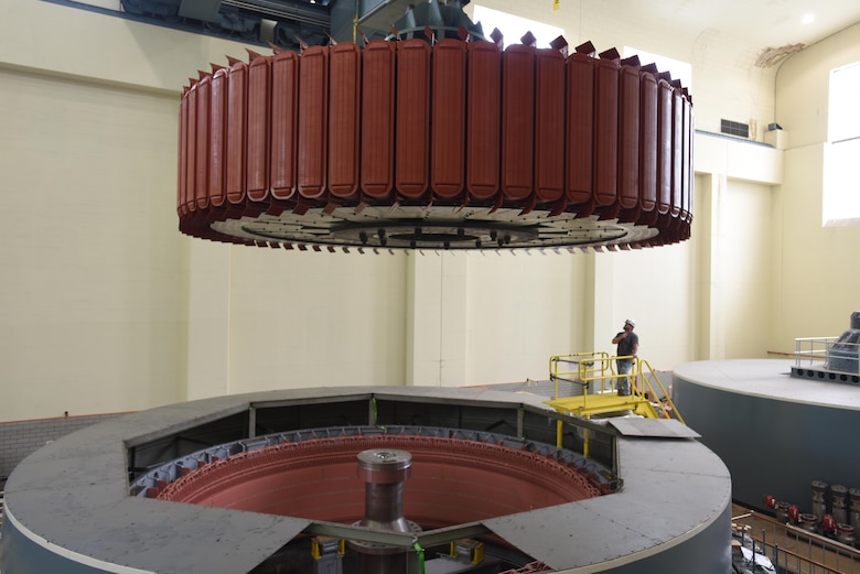 Kye Moss of Voith Hydro guides a 249-ton rotor during its installation into hydropower unit two at Center Hill Dam in Lancaster, Tenn., June 19, 2017. The U.S. Army Corps of Engineers Nashville District is rehabilitating the unit and expects to bring it online in late July after the completion of its assembly and load testing.