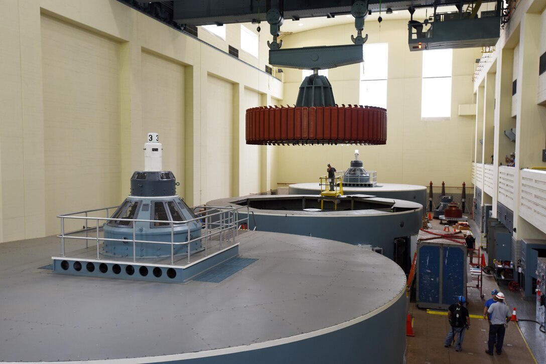 Kye Moss of Voith Hydro guides a 249-ton rotor during its installation into hydropower unit two at Center Hill Dam in Lancaster, Tenn., June 19, 2017. The U.S. Army Corps of Engineers Nashville District is rehabilitating the unit and expects to bring it online in late July after the completion of its assembly and load testing.