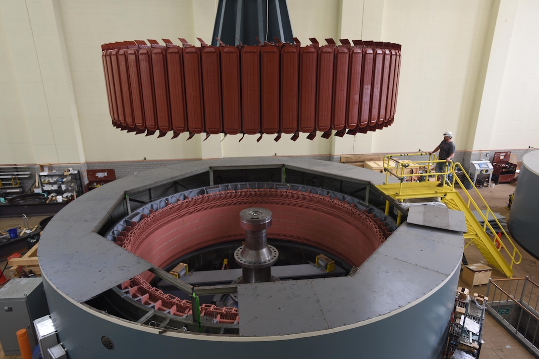 Kye Moss of Voith Hydro guides a 249-ton rotor during its installation into hydropower unit two at Center Hill Dam in Lancaster, Tenn., June 19, 2017. The U.S. Army Corps of Engineers Nashville District is rehabilitating the unit and expects to bring it online in late July after the completion of its assembly and load testing.