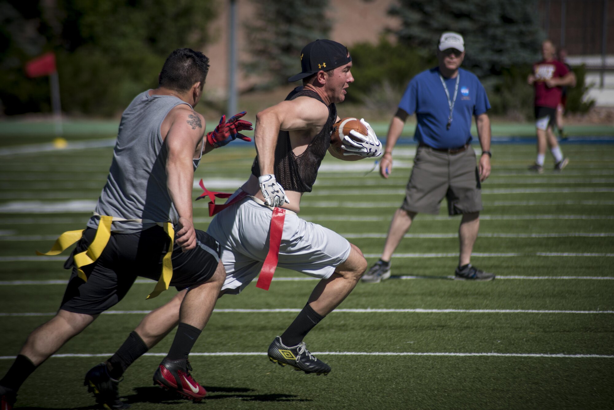 PETERSON AIR FORCE BASE, Colo. - Team Pete Airmen compete in a flag football game during Sports and Field Day, June 15, 2017, at Peterson Air Force Base, Colo. Each game consisted of two 15 minute halves. (U.S. Air Force photo by Senior Airman Dennis Hoffman)