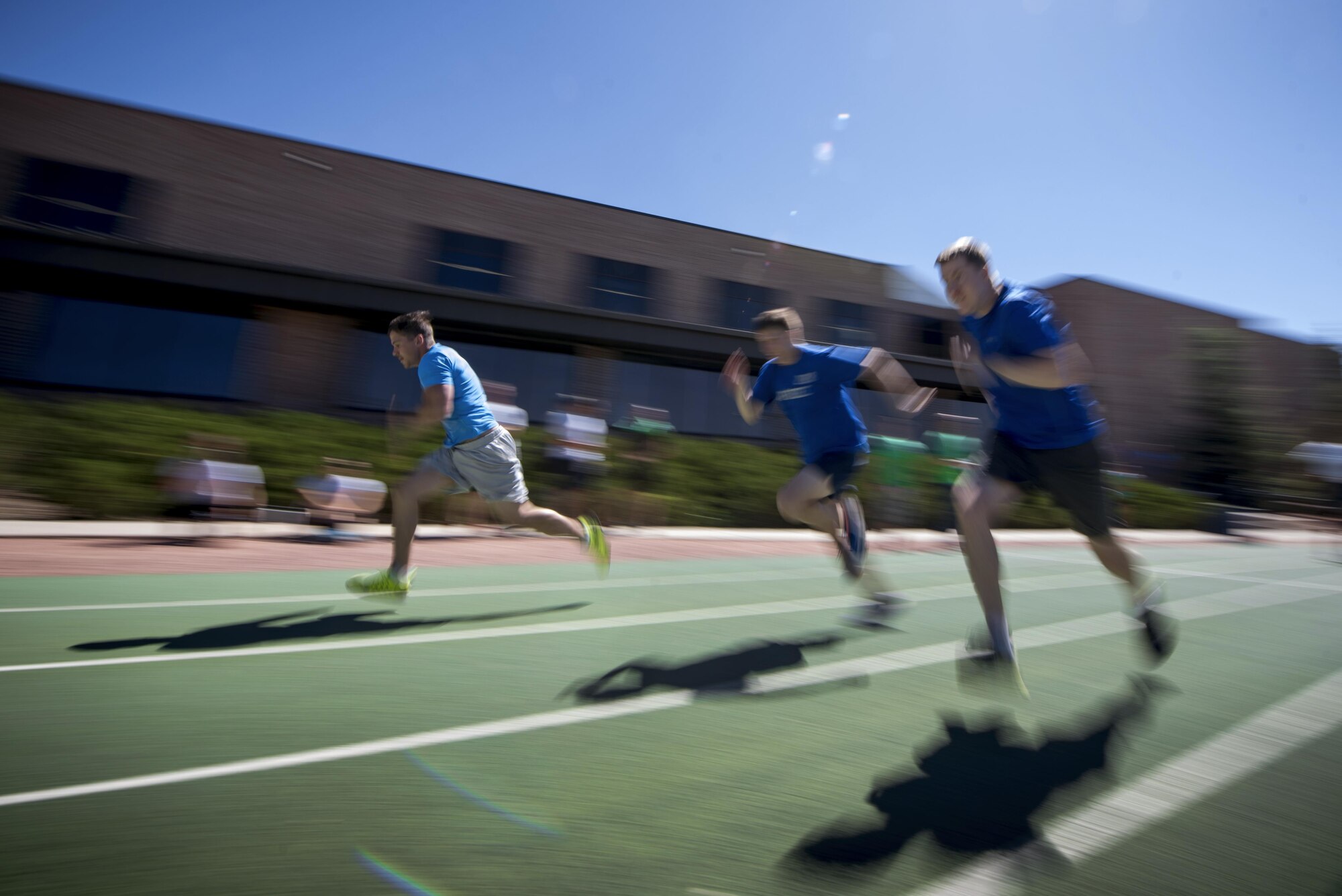 PETERSON AIR FORCE BASE, Colo. - Team Pete Airmen race each other during a 100-meter dash during Sports and Field Day, June 15, 2017, at Peterson Air Force Base, Colo. Scoring for singles events were seven points for first place, five points for second place and three points for third place. (U.S. Air Force photo by Senior Airman Dennis Hoffman)