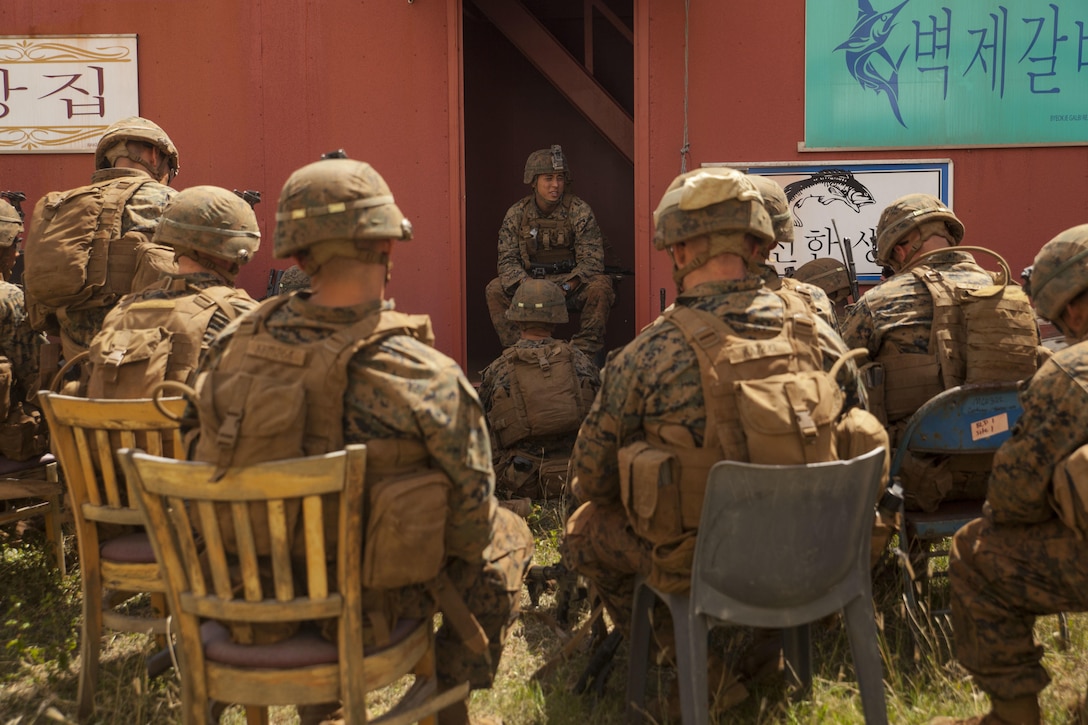 MARINE CORPS BASE HAWAII – Cpl. Aaron Yoshimura, a squad leader with Kilo Company, 3rd Battalion, 3rd Marine Regiment, briefs his squad on the ‘Recon, Isolation, Secure a foothold and Seize the objective’ process for his Marines during Exercise Bougainville 1-17.2 aboard Marine Corps Base Hawaii, June 17, 2017. The unit went over procedures and the basics of their roles as infantrymen for Exercise Bougainville, a two-week training exercise to enhance their lethality and effectiveness as a force in readiness. Kilo Co. conducted Military Operation in Urban Terrain training in which Marines practiced clearing buildings, wrapping tourniquets on simulated wounds, weapon drills and lessons on urban tactics. (U.S. Marine Corps photo by Cpl. Jesus Sepulveda Torres)