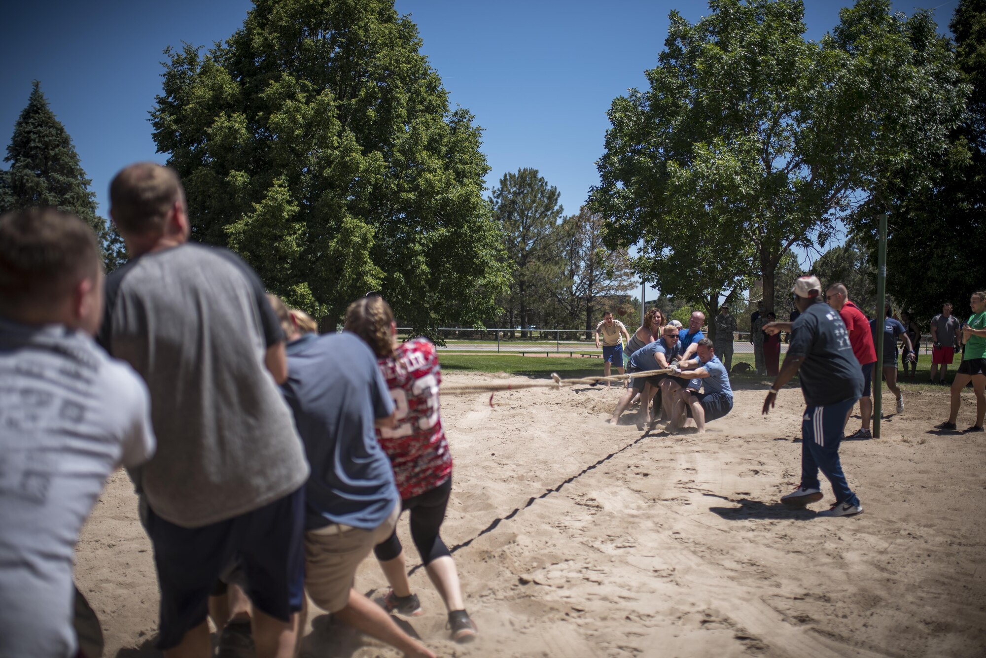 PETERSON AIR FORCE BASE, Colo. - Team Pete Airmen face off in a battle of tug-of-war to culminate Sports and Field Day, June 15, 2017, at Peterson Air Force Base, Colo. Each team had a weight limit of 1500 pounds. (U.S. Air Force photo by Senior Airman Dennis Hoffman)
