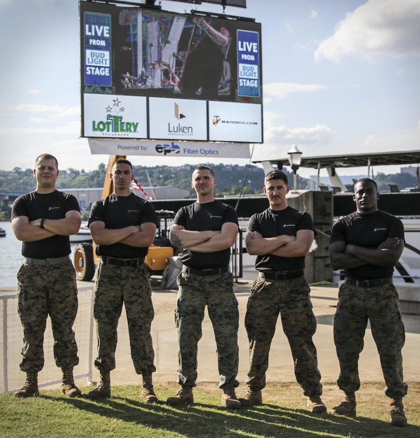 U.S. Marines with Recruiting Substation (RSS) Chattanooga and RSS West Georgia stand in front of a Marines advertisement during the Riverbend Festival in Chattanooga, Tennessee, June 11, 2017. Marines challenged Riverbend Festival attendees to do as many Marine Corps pull-ups as they could. (U.S. Marine Corps photo by Sgt. Mandaline Hatch)