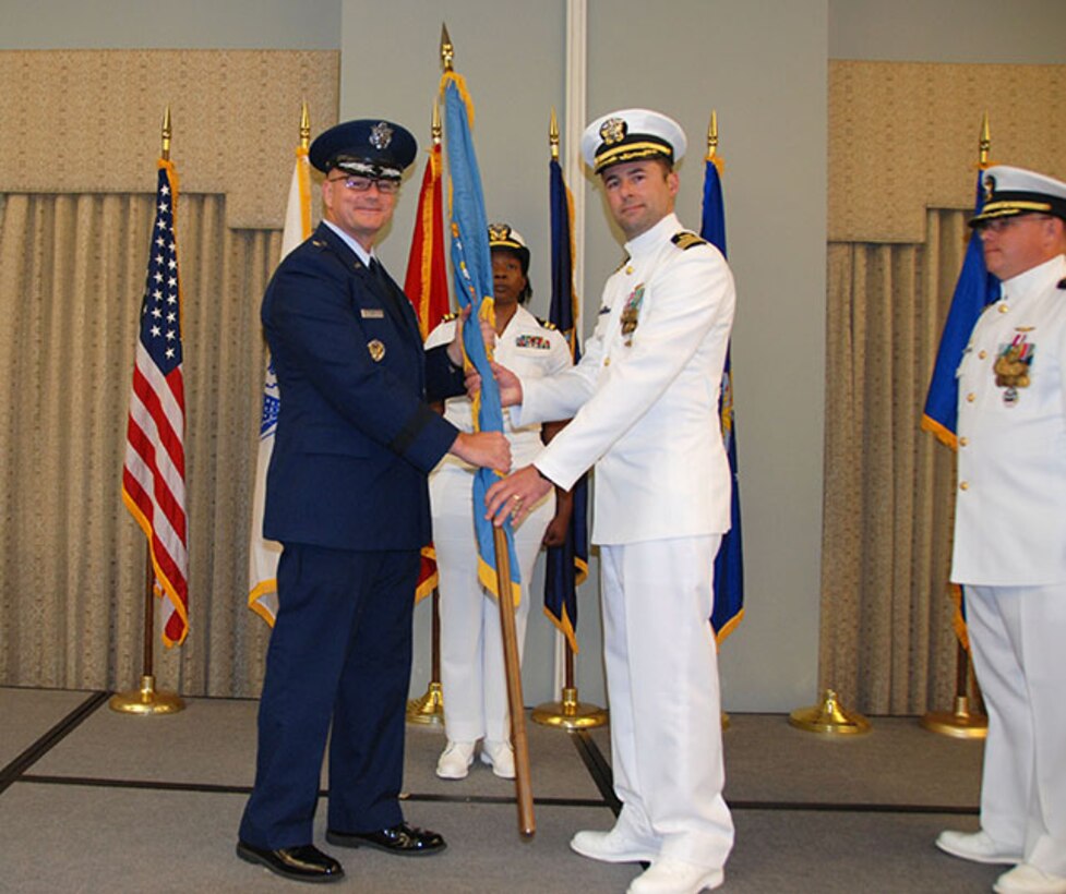 Navy Cmdr. Keith Klemm receives the Defense Logistics Agency Aviation flag from DLA Aviation Commander Air Force Brig. Gen. Allan Day June 16, 2017 during a DLA Aviation - Cherry Point, North Carolina, change of command ceremony held on Marine Corps Air Station Cherry Point.  Klemm replaces Navy Cmdr. James Neuman (right), who retires after a 24-year Navy career effective Sept. 1.