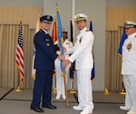 Navy Cmdr. Keith Klemm receives the Defense Logistics Agency Aviation flag from DLA Aviation Commander Air Force Brig. Gen. Allan Day June 16, 2017 during a DLA Aviation - Cherry Point, North Carolina, change of command ceremony held on Marine Corps Air Station Cherry Point.  Klemm replaces Navy Cmdr. James Neuman (right), who retires after a 24-year Navy career effective Sept. 1.