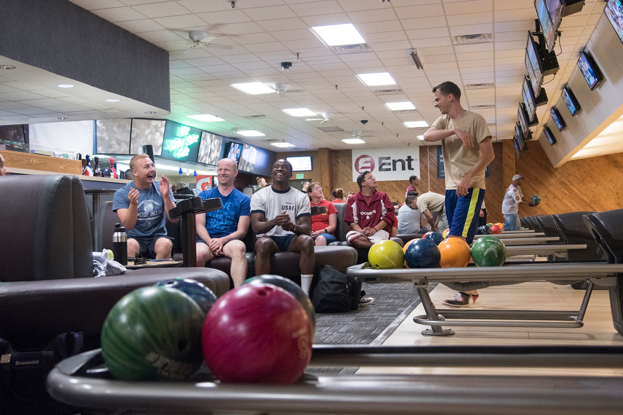 PETERSON AIR FORCE BASE, Colo. - Team Pete Airmen laugh while bowling for unity points at the Bowling Center during the annual Sports and Field Day, June 15, 2017, at Peterson Air Force Base, Colo. Every year Team Pete units compete for points by participating, volunteering and winning in various sports including running, biking track events, golf, table tennis and many more. (U.S. Air Force photo by Staff Sgt. Tiffany Lundberg)
