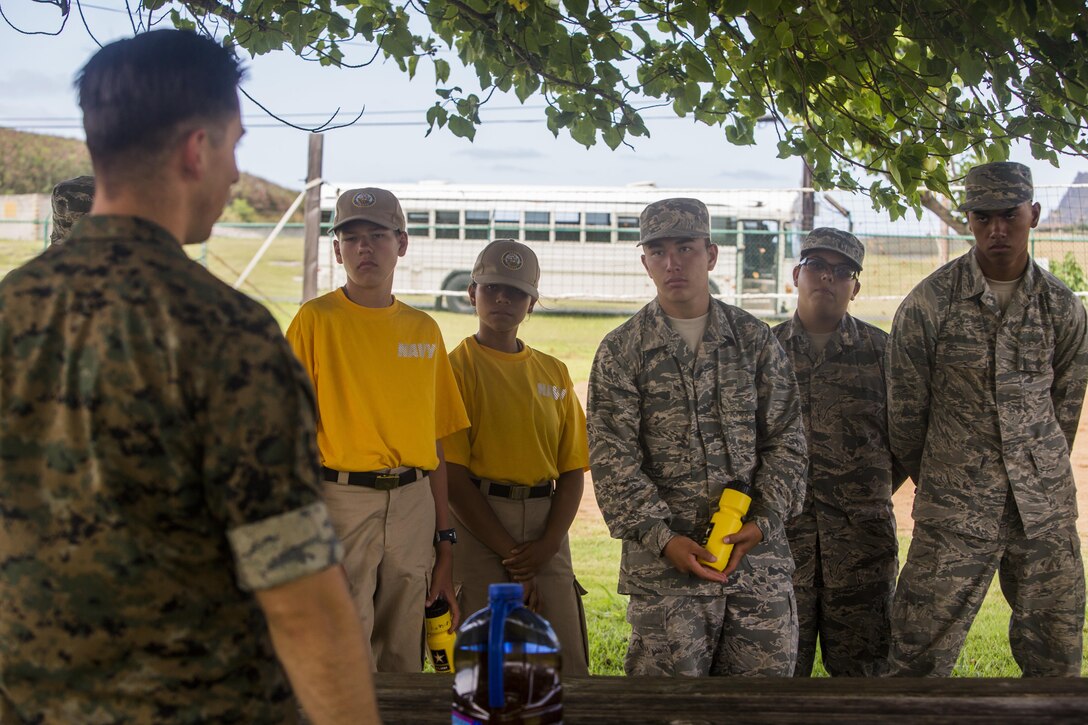 An explosive ordnance disposal technician with Headquarters Battalion, gives a description of unit’s capabilities to Air Force and Navy Junior Reserve Officer Training Corps cadets during a tour aboard Marine Corps Base Hawaii, June 15, 2017. The JROTC cadets were given a base tour to observe MCB Hawaii operations. (U.S. Marine Corps photo by Lance Cpl. Isabelo Tabanguil)