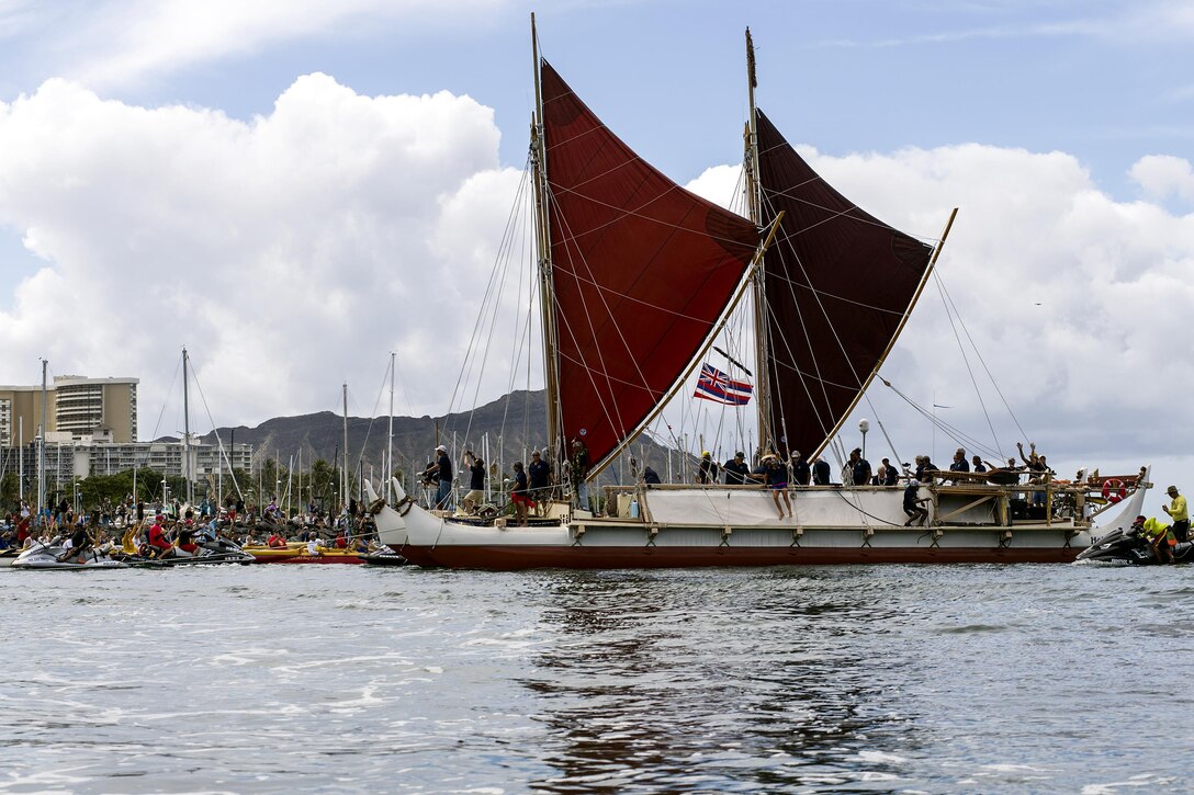 The traditional Polynesian double-hulled voyaging canoe Hokule‘a returns to Honolulu, June 17, 2017, from a 36-month tour around the world. The Hokuleʻa sailed more than 40,000 nautical miles using only star navigation to spread the message of Malama Honua, or caring for the Earth, to 85 ports and 26 nations. Navy Photo by Petty Officer 2nd Class Gabrielle Joyner