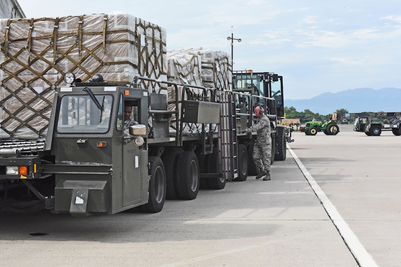 Technical Sgt. Jonathan Rasmussen, small air terminal section chief at Joint Task Force-Bravo, guides two of his teammates as they load cargo onto a truck at Soto Cano Air Base, June 13, 2017. The supplies the small air terminal handles vary from medication, food and supplies to meet service members’ needs on base, to humanitarian assistance supplies received through the U.S. Agency for International Development’s Denton Program.