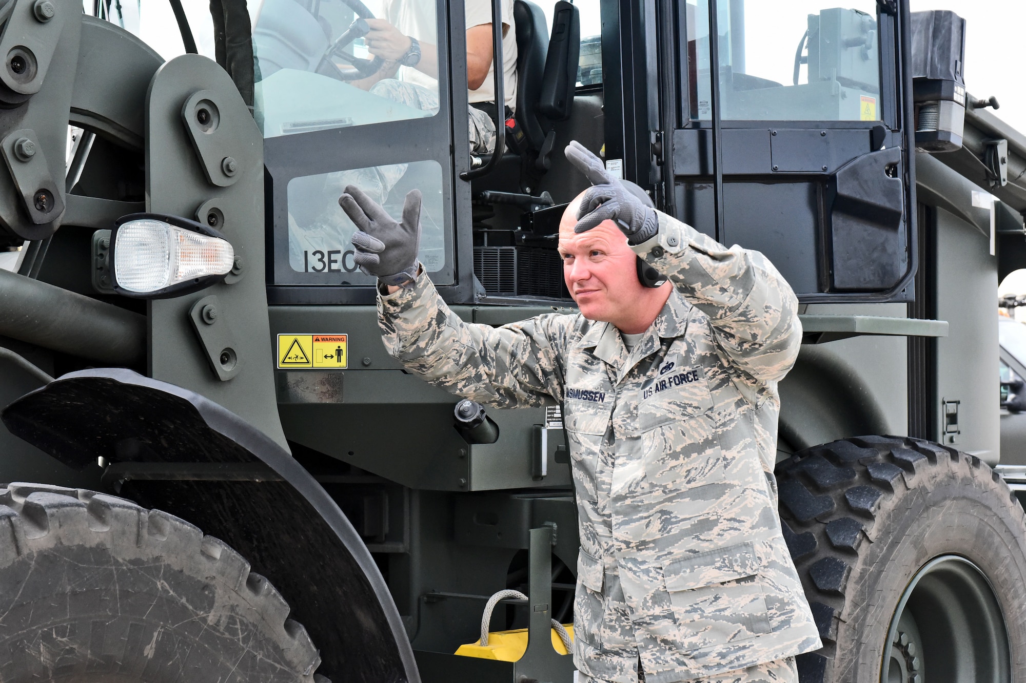 Technical Sgt. Jonathan Rasmussen, small air terminal section chief at Joint Task Force-Bravo, signals his teammates as they load cargo onto a truck at Soto Cano Air Base, June 13, 2017. The supplies the small air terminal handles vary from medication, food and supplies to meet service members’ needs on base, to humanitarian assistance supplies received through the U.S. Agency for International Development’s Denton Program.