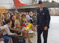 Carla Abba glances down at the bouquet of flowers from her husband, Col. David Abba, the new 53rd Wing commander, during his change of command June 20 at EglinAir Force Base, Fla. The wing also welcomed their children. Nyah, Jack, Serena, Lauren and Lani Abba. (U.S. Air Force photo/Ilka Cole) 
