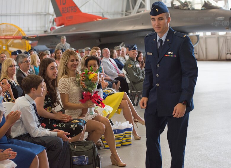 Carla Abba glances down at the bouquet of flowers from her husband, Col. David Abba, the new 53rd Wing commander, during his change of command June 20 at EglinAir Force Base, Fla. The wing also welcomed their children. Nyah, Jack, Serena, Lauren and Lani Abba. (U.S. Air Force photo/Ilka Cole) 
