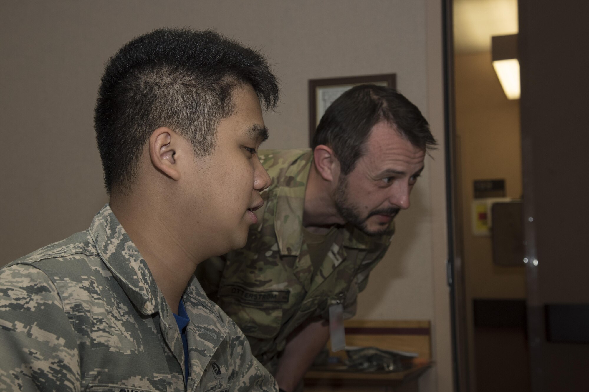 U.S. Air Force Airman 1st Class Anthony Ohara, a 35th Operations Support Squadron weather forecaster, briefs Royal Danish Army Capt. Andreas Otterstoem, a 116th Air Support Operations Squadron joint terminal attack controller, on the weather forecast for the day during RED FLAG-Alaska 17-2, at Eielson Air Force Base, Alaska, June 16, 2017. Misawa's weather Airmen briefed other nations including the Royal Thai Air Force, Republic of Korea and the Japan Air Self-Defense Force. (U.S. Air Force photo by Airman 1st Class Sadie Colbert)