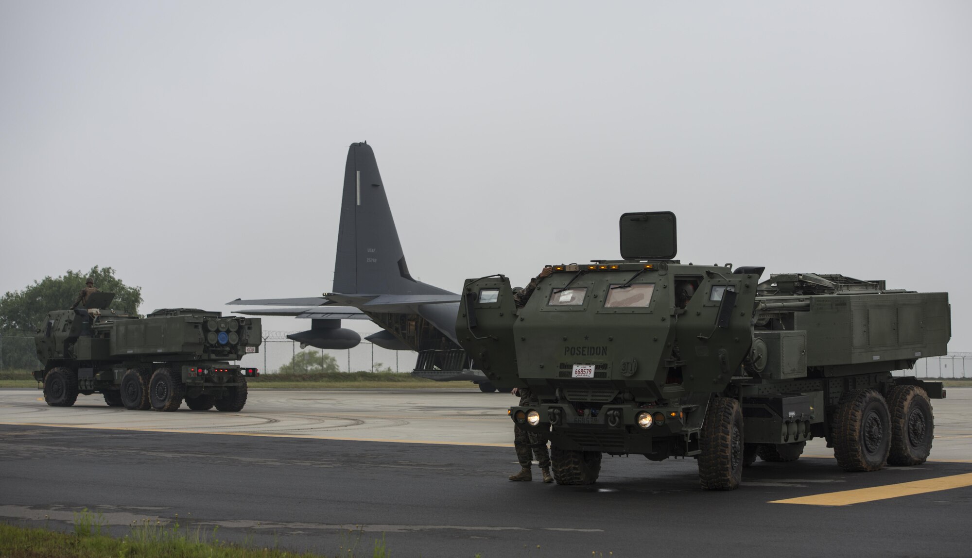 Two U.S. Marine Corps High Mobility Artillery Rocket System (HIMARS) assigned to 12th Marine Regiment, 3rd Marine Division prepare to load onto a U.S. Air Force MC-130J Commando II assigned to the 353rd Special Operations Group following a readiness drill, June 1, 2017 at Kunsan Air Base, Republic of Korea. The training exercise conducted between the U.S. Air Force and Marine Corps strengthens joint interoperability and working relationship between the armed services. (U.S. Air Force photo by Capt. Jessica Tait)