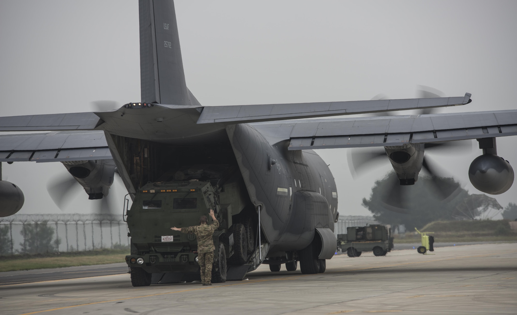 A U.S. Marine Corps High Mobility Artillery Rocket System (HIMARS) assigned to 12th Marine Regiment, 3rd Marine Division loads onto a U.S. Air Force Special Operations Command MC-130J Commando II assigned to the 353rd Special Operations Group following a readiness drill, June 1, 2017 at Kunsan Air Base, Republic of Korea. The tactical level exchanges and realistic scenario-based mission executed during the joint training exercise increased interoperability and partner capacity with between the U.S Air Force and Marine Corps. (U.S. Air Force photo by Capt. Jessica Tait)