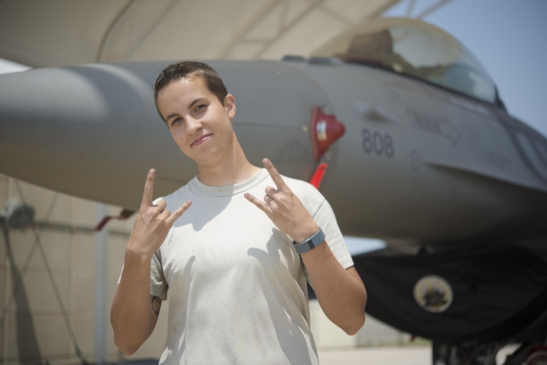 Air Force Airman 1st Class Jaimie Smith, a 14th Fighter Squadron maintenance crew chief, poses for a photo in front of an F-16 Fighting Falcon jet fighter at Kunsan Air Base, South Korea, June 15, 2017. Air Force photo by Senior Airman Jarrod Vickers