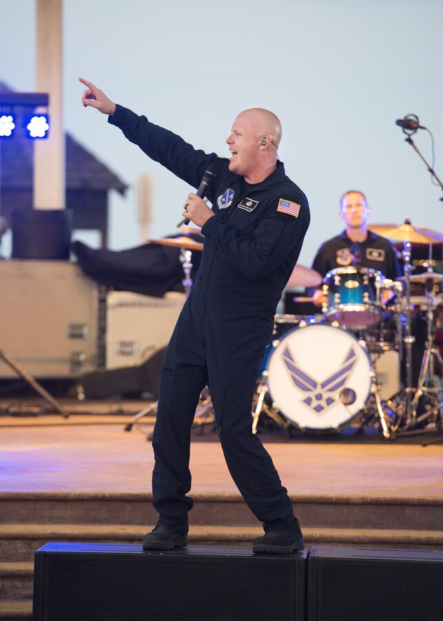 Senior Master Sgt. Ryan Carson, Max Impact vocalist and superintendent, sings during a concert June 17, 2017, at the Rehoboth Beach Bandstand, in Rehoboth Beach, Del. The band’s high-energy performances assist in enhancing troop morale, building partnerships with local, national and international communities, increasing recruiting and retention efforts and inspiring patriotism using effective and powerful music. (U.S. Air Force photo by Senior Airman Zachary Cacicia)