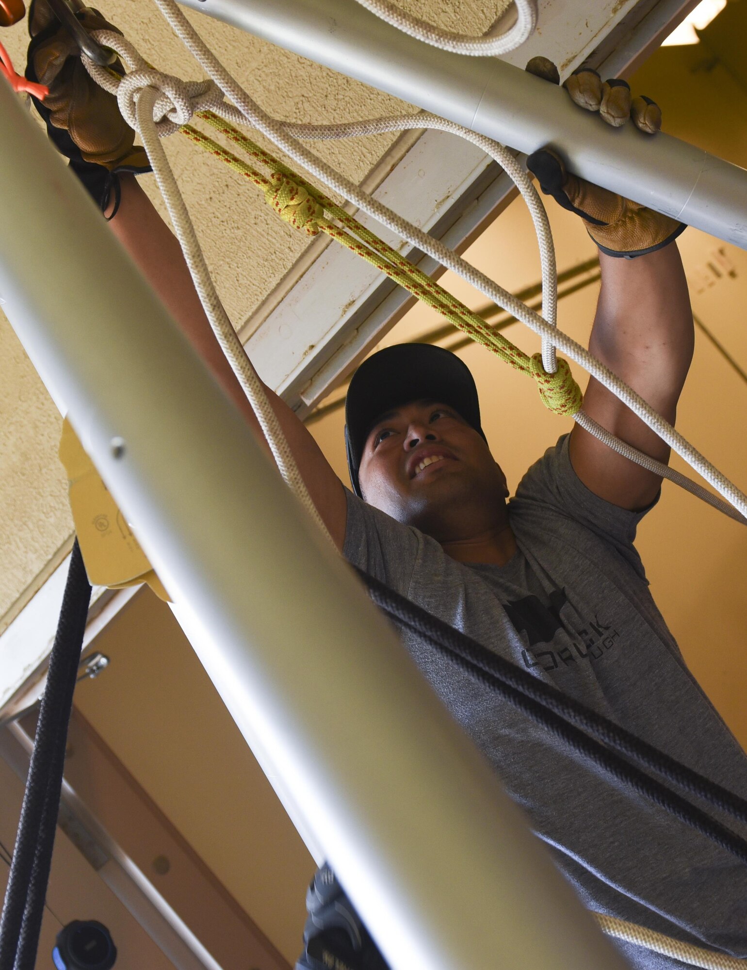 U.S. Air Force Staff Sgt. Rico Blas Castro, 8th Civil Engineer Squadron fire emergency services emergency communications center noncommissioned officer in charge, attaches a carabiner to a tripod during the Department of Defense Technical Rescue Course at Kunsan Air Base, Republic of Korea, June 8, 2017. During the course students were taught high and low angle, confined space, and technical rope rescues. (U.S. Air Force photo by Senior Airman Michael Hunsaker/Released)