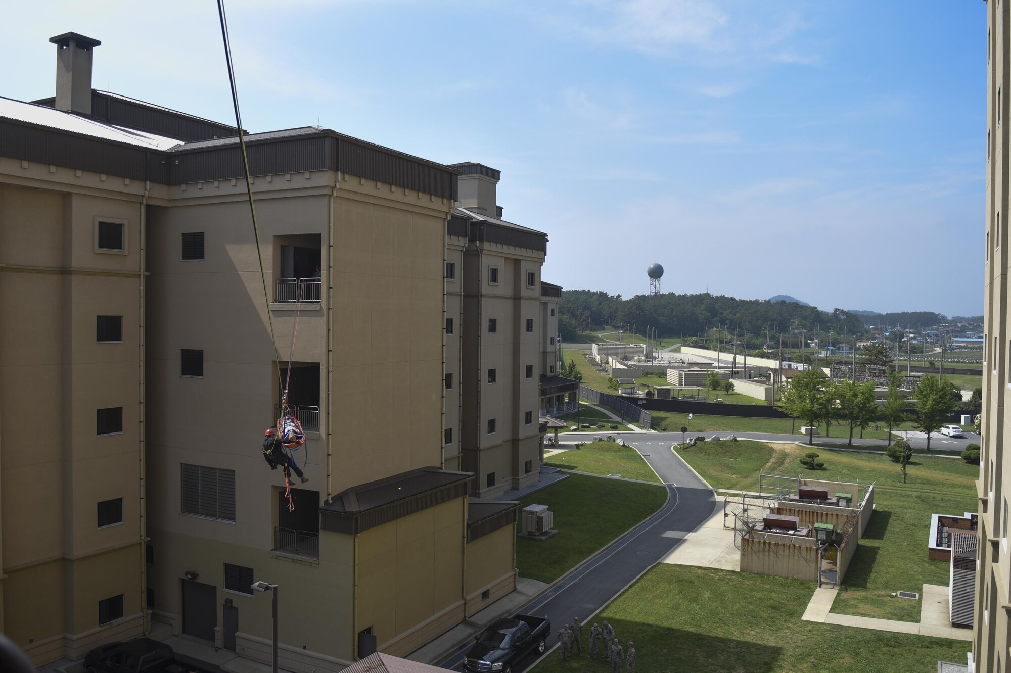 U.S. Air Force Staff Sgt. Adam Carroll, 8th Civil Engineer Squadron fire emergency services lead firefighter, escorts a simulated victim in a Stokes basket as it is lowered during training at Kunsan Air Base, Republic of Korea, June 8, 2017. Carroll participated in the Department of Defense Technical Rescue Course which taught students from the Pacific Air Forces region high and low angle, confined space, and technical rope rescues. (U.S. Air Force photo by Senior Airman Michael Hunsaker/Released)