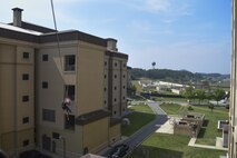U.S. Air Force Staff Sgt. Adam Carroll, 8th Civil Engineer Squadron fire emergency services lead firefighter, escorts a simulated victim in a Stokes basket as it is lowered during training at Kunsan Air Base, Republic of Korea, June 8, 2017. Carroll participated in the Department of Defense Technical Rescue Course which taught students from the Pacific Air Forces region high and low angle, confined space, and technical rope rescues. (U.S. Air Force photo by Senior Airman Michael Hunsaker/Released)