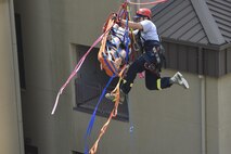 U.S. Air Force Senior Airman Donavin Apiag, 8th Civil Engineer Squadron fire emergency services driver/operator, flips a stokes basket on its side as part of a simulated event during the Department of Defense Technical Rescue Course at Kunsan Air Base, Republic of Korea, June 8, 2017. Apiag participated in the DoD Technical Rescue Course, which taught students from the Pacific Air Forces region high and low angle, confined space, and technical rope rescues. (U.S. Air Force photo by Senior Airman Michael Hunsaker/Released)