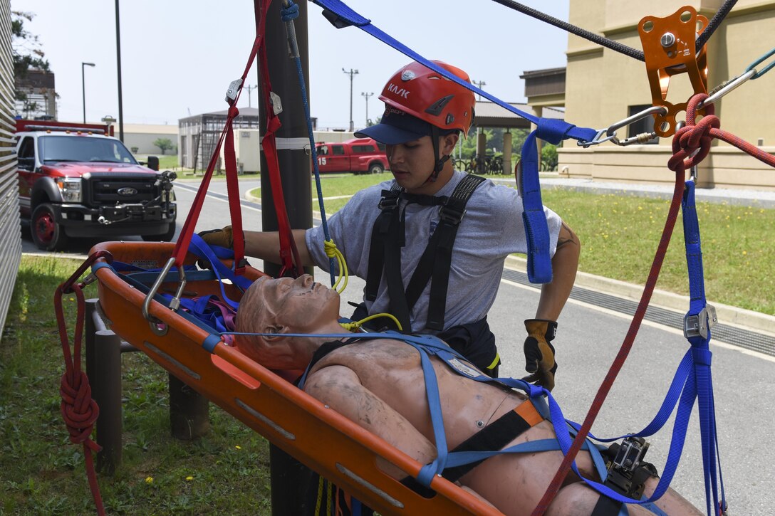 U.S. Air Force Senior Airman Donavin Apiag, 8th Civil Engineer Squadron fire emergency services driver/operator assists in lowering a simulated victim during training at Kunsan Air Base, Republic of Korea, June 8, 2017. Apiag participated in the Department of Defense Technical Rescue Course, which taught students from the Pacific Air Forces region high and low angle, confined space, and technical rope rescues. (U.S. Air Force photo by Senior Airman Michael Hunsaker/Released)