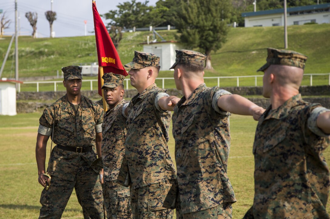 U.S. Marine Corps Sgt. Marquis Rosen, with Communications Company, Headquarters Battalion, 3d Marine Division, checks his marines for alignment during a drill competition at the Courtney Bowl on Camp Courtney, Okinawa, Japan, March 31, 2017. Headquarters Company, Truck Company, and Communications Company engaged in a competition against each other for a drill trophy and to aid in preparation for an upcoming commanding general inspection.  (U.S. Marine Corps photo by MCIPAC Combat Camera Lance Cpl.  Jesus McCloud)