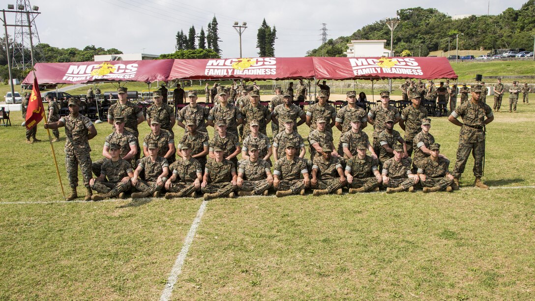 U.S. Marines with Communications Company, Headquarters Battalion, 3d Marine Division, pose for a group photo after the drill competition held at the Courtney Bowl on Camp Courtney, Okinawa, Japan, March 31, 2017. Headquarters Company, Truck Company, and Communications Company engaged in a competition against each other for a drill trophy and to aid in preparation for an upcoming commanding general inspection.  (U.S. Marine Corps photo by MCIPAC Combat Camera Lance Cpl.  Jesus McCloud)