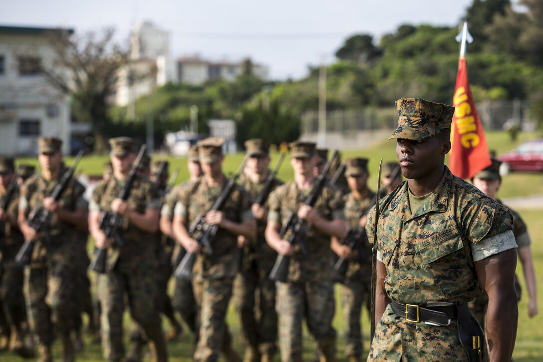 U.S. Marine Corps Sgt. Andrew Smith, with Headquarters Company, Headquarters Battalion, 3d Marine Division, commands his Marines to “fall in” during a drill competition at the Courtney Bowl, on Camp Courtney, Okinawa, Japan, March 31, 2017. Headquarters Company, Truck Company, and Communications Company engaged in a competition against each other for a drill trophy and to aid in preparation for an upcoming commanding general inspection.  (U.S. Marine Corps photo by MCIPAC Combat Camera Lance Cpl.  Jesus McCloud)