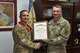 3rd Battalion, 4th Air Defense Artillery Regiment Command Sgt. Major Matthew Perton presents 380th Air Expeditionary Wing Command Chief Master Sgt. Brian Kruzelnick with the Honorable Order of Saint Barbara at an undisclosed location in southwest Asia, June 16, 2017.