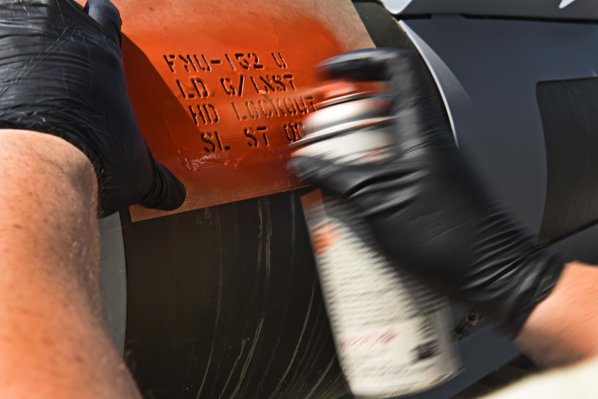 U.S. Air Force Airman 1st Class Isaac Kala, 447th Expeditionary Aircraft Maintenance Squadron munitions stockpile member, stencils information onto a joint direct attack munition guided bomb unit 31 June 16, 2017, at Incirlik Air Base, Turkey. Airmen working with munitions receive, identify and store guided and unguided munitions. (U.S. Air Force photo by Airman 1st Class Kristan Campbell)