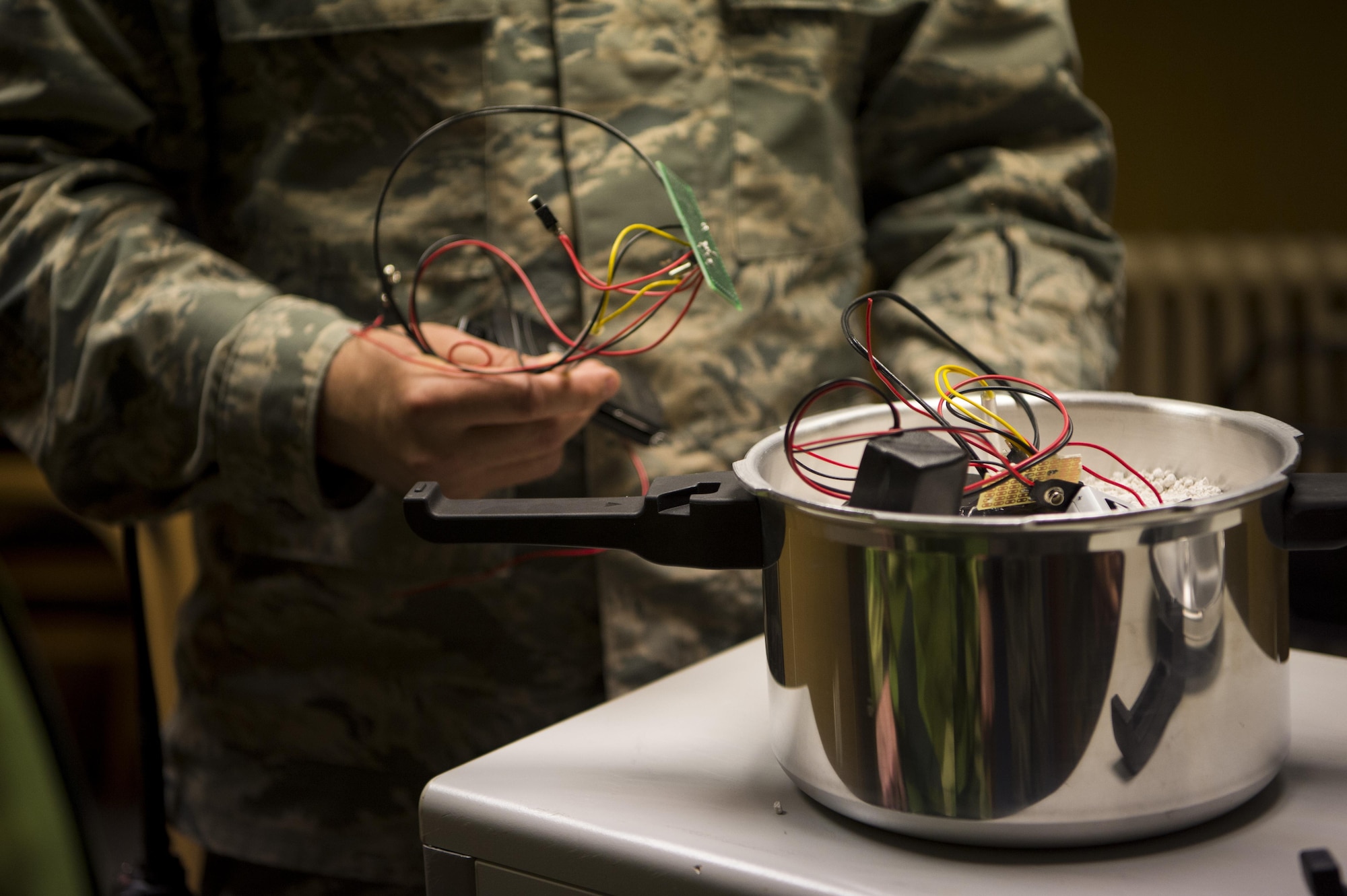 U.S. Air Force Staff Sgt. Brooke Hamilton, 52nd Civil Engineer Squadron explosive ordnance disposal team leader, shows a mock improvised explosive device during the second annual multilateral IED Rodeo at Spangdahlem Air Base, Germany, June 12, 2017. EOD teams and members from seven different units had the opportunity to participate in and observe different IED scenarios during the almost week long training. The mock IED scenarios were based on real life happenings from current world events. (U.S. Air Force photo by Senior Airman Preston Cherry)