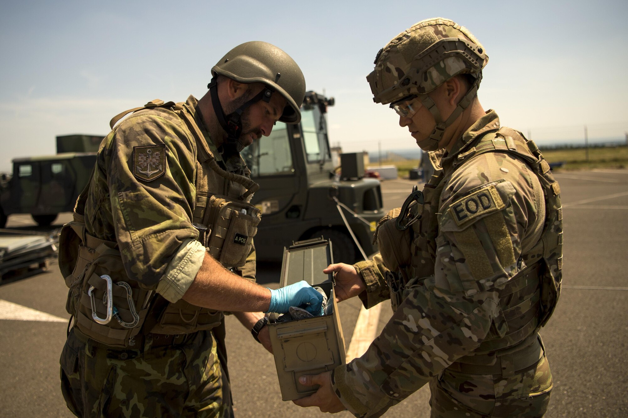 U.S. Air Force Staff Sgt. Arlen Calhoun, 786th Civil Engineer Squadron explosive ordnance disposal team member, holds an evidence tool box open for Army of the Czech Republic Sgt. 1st Class Milan Pagurko, EOD member, during the second annual multilateral Improvised Explosive Device Rodeo at Spangdahlem Air Base, Germany, June 15, 2017. EOD members from Germany, Czech Republic, The Netherlands, Sweden, Ramstein Air Base, Spangdahlem Air Base, and Grissom Air Reserve Base, Indiana took part in the five day event to train on IED’s while learning tactics, techniques and procedures from each other. (U.S. Air Force photo by Senior Airman Preston Cherry)