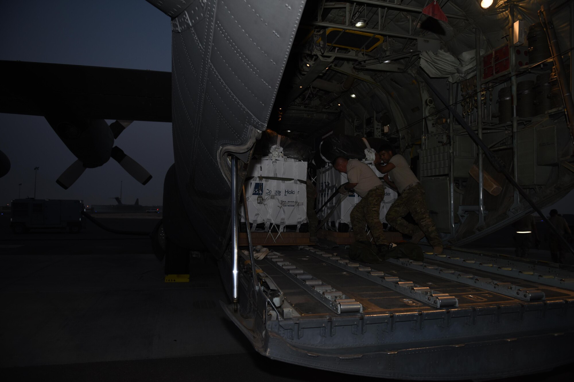 Loadmasters with the 737th Expeditionary Airlift Squadron work together to secure a container delivery system in the cargo bay of a C-130 Hercules in preparation for an air drop at an undisclosed location in Southwest Asia, over the weekend. Providing the fuel that keeps the fight going, the 386th Air Expeditionary Wing has delivered more than 80 tons of food, water and other supplies to various supported forces throughout the U.S. Air Forces Central Command area of responsibility in support of Combined Joint Task Force - Operation Inherent Resolve ground troops. (U.S. Air Force photo/Tech. Sgt. Jonathan Hehnly)
