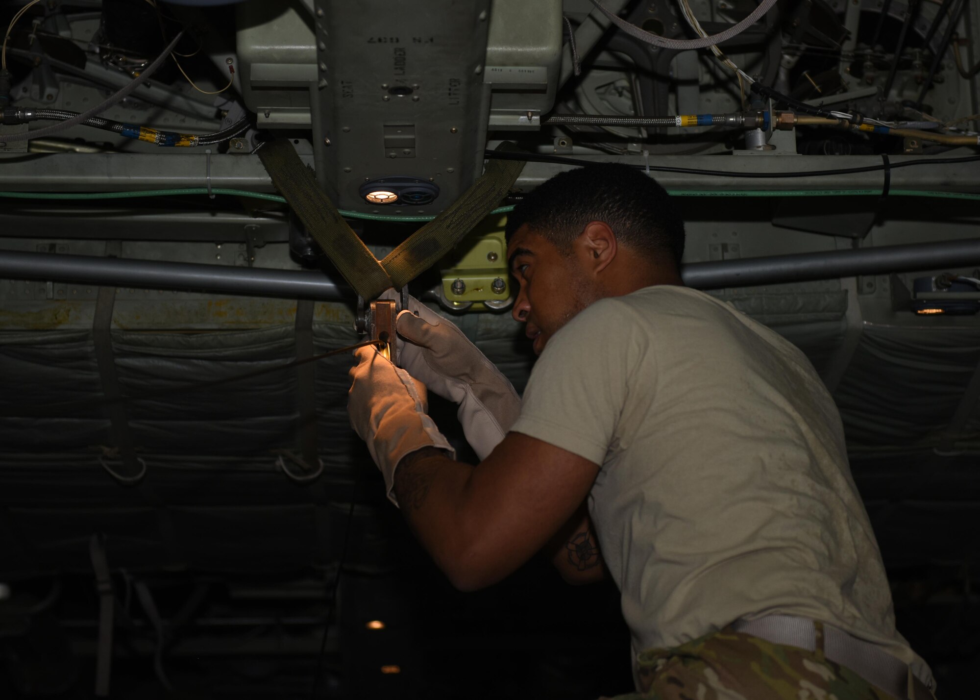 Tech. Sgt. Jimmy Sealey, a loadmaster with the 737th Expeditionary Airlift Squadron, installs a pulley that is part of the container delivery system in the cargo bay of a C-130 Hercules in preparation for an air drop at an undisclosed location in Southwest Asia, over the weekend. Providing the fuel that keeps the fight going, the 386thAir Expeditionary Wing has delivered more than 80 tons of food, water and other supplies to various supported forces throughout the U.S. Air Forces Central Command area of responsibility in support of Combined Joint Task Force - Operation Inherent Resolve ground troops. (U.S. Air Force photo/Tech. Sgt. Jonathan Hehnly)