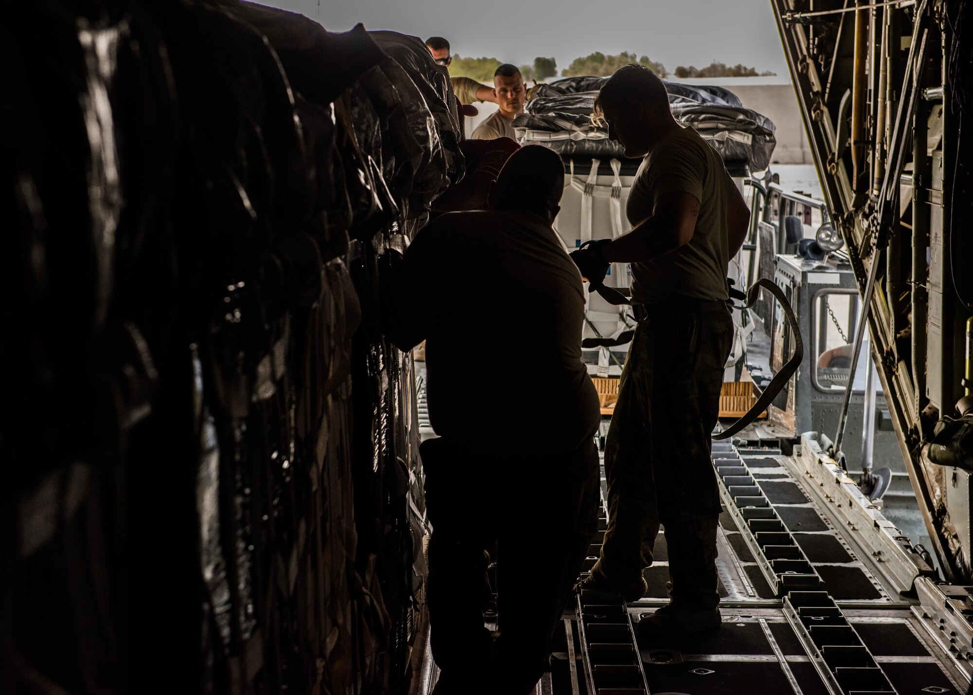 Loadmasters with the 737th Expeditionary Airlift Squadron and air transportation specialists with the 386th Expeditionary Logistics Readiness Squadron work together to load container delivery systems into the cargo bay of a C-130 Hercules in preparation for an air drop at an undisclosed location in Southwest Asia, over the weekend. Providing the fuel that keeps the fight going, the 386th Air Expeditionary Wing has delivered more than 80 tons of food, water and other supplies to various supported forces throughout the U.S. Air Forces Central Command area of responsibility in support of Combined Joint Task Force - Operation Inherent Resolve ground troops. (U.S. Air Force photo/Tech. Sgt. Jonathan Hehnly)