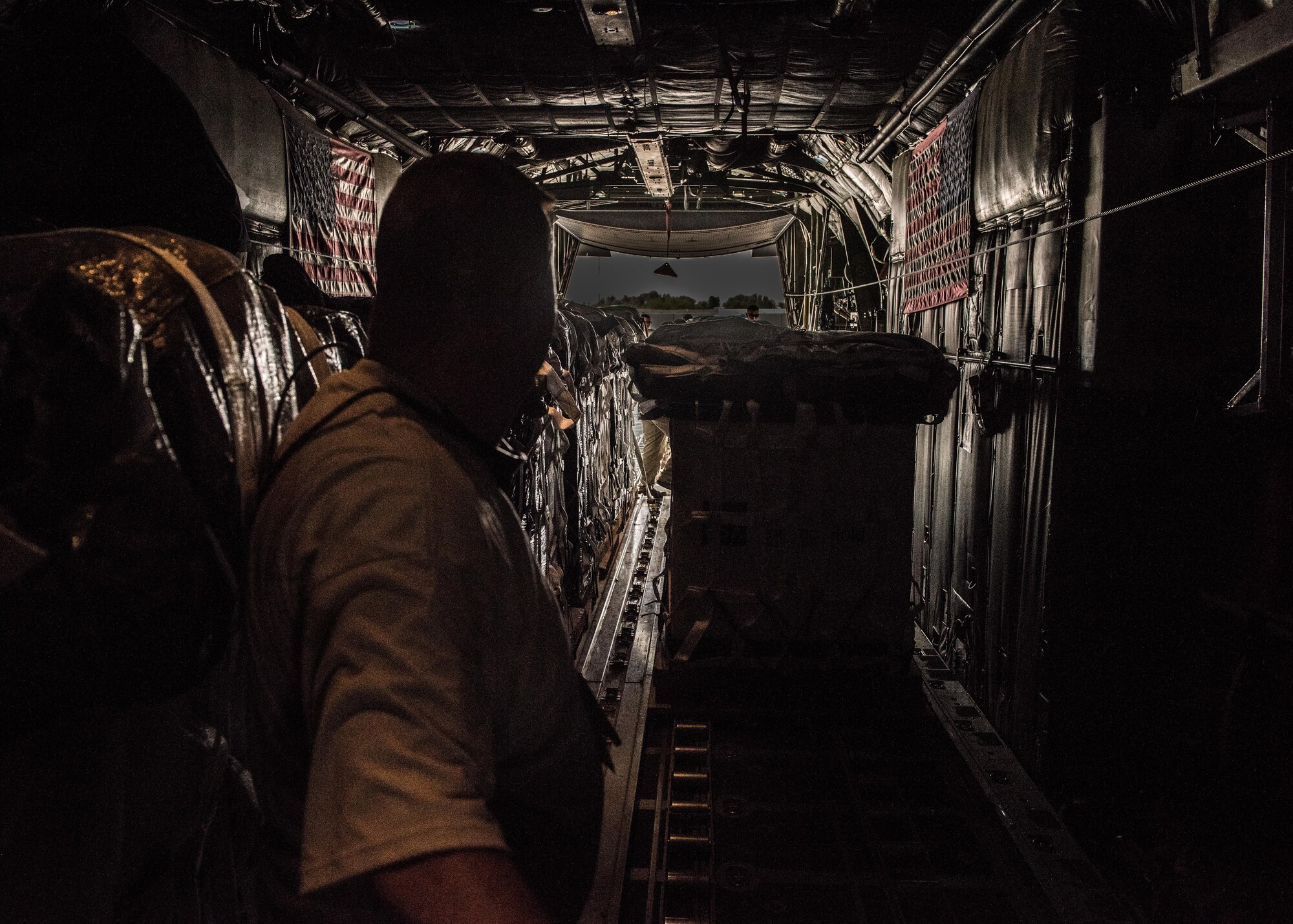 Chief Master Sgt. Ned Seaman, a loadmaster with the 737th Expeditionary Airlift Squadron, receives a container delivery system in the cargo bay of a C-130 Hercules in preparation for an air drop at an undisclosed location in Southwest Asia, over the weekend. Providing the fuel that keeps the fight going, the 386th Air Expeditionary Wing has delivered more than 80 tons of food, water and other supplies to various supported forces throughout the U.S. Air Forces Central Command area of responsibility in support of Combined Joint Task Force - Operation Inherent Resolve ground troops. (U.S. Air Force photo/Tech. Sgt. Jonathan Hehnly)