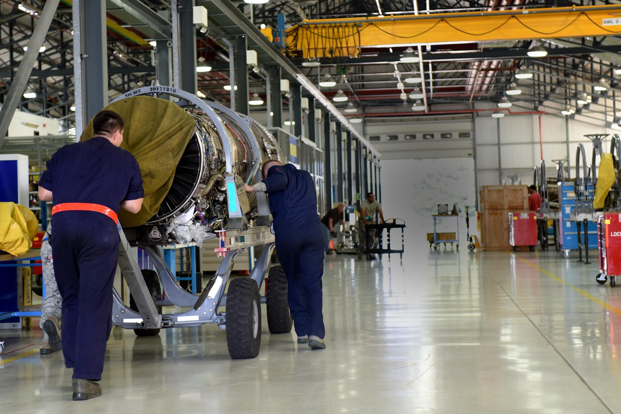 Airmen assigned to the 48th Component Maintenance Squadron push an F-15 engine in to the propulsions shop at Royal Air Force Lakenheath, England, June 13. Part of the 48th CMS’s responsibilities include the routine maintenance of F-15 engines. (U.S. Air Force photo/Airman 1st Class Eli Chevalier)