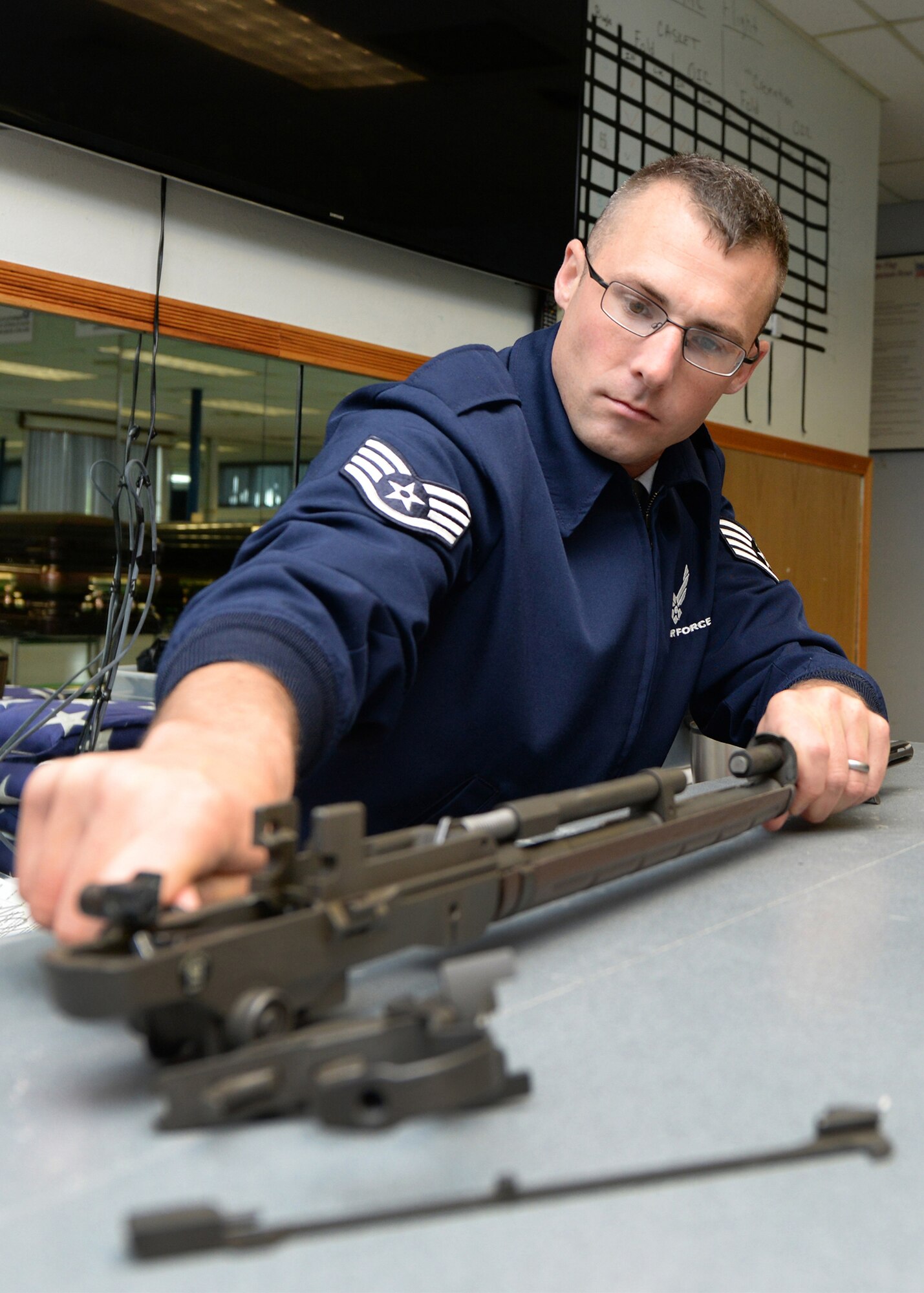 Staff Sgt. Lee C. Shortell, a ceremonial guardsman for the Patriot Honor Guard, reassembles a ceremonial rifle at the team's facility on base June 20. The Patriot Honor Guard team provides military funeral honors throughout New England and parts of New York for active duty, retired members and veterans who served in the United States Air Force honorably. (U.S. Air Force photo by Linda LaBonte Britt)
