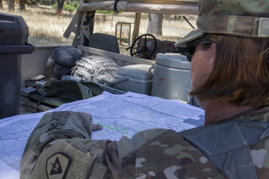 U.S. Army Sgt. Cindi Destefano, an Observer Controller Trainer (OCT) from the 3rd of the 290th Regiment, plots various traveling units positions on a map during the 91st Training Division’s Warrior Exercise on Fort Hunter Liggett, Calif. June 15, 2017. As an OCT, Destefano has to observe units during training to find weak spots, in order to make corrections for the unit to learn from. (Photo by Spc. Eric Unwin/released)